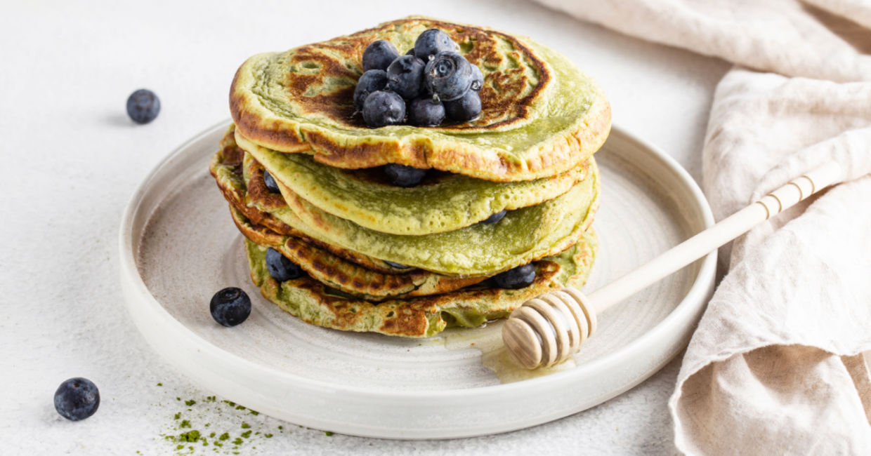 Matcha pancakes topped with blueberries. Matcha pancakes topped with blueberries.