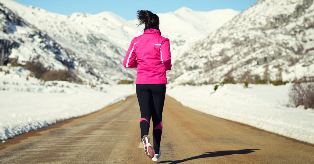 Motivated woman running during the winter. Motivated woman running during the winter.