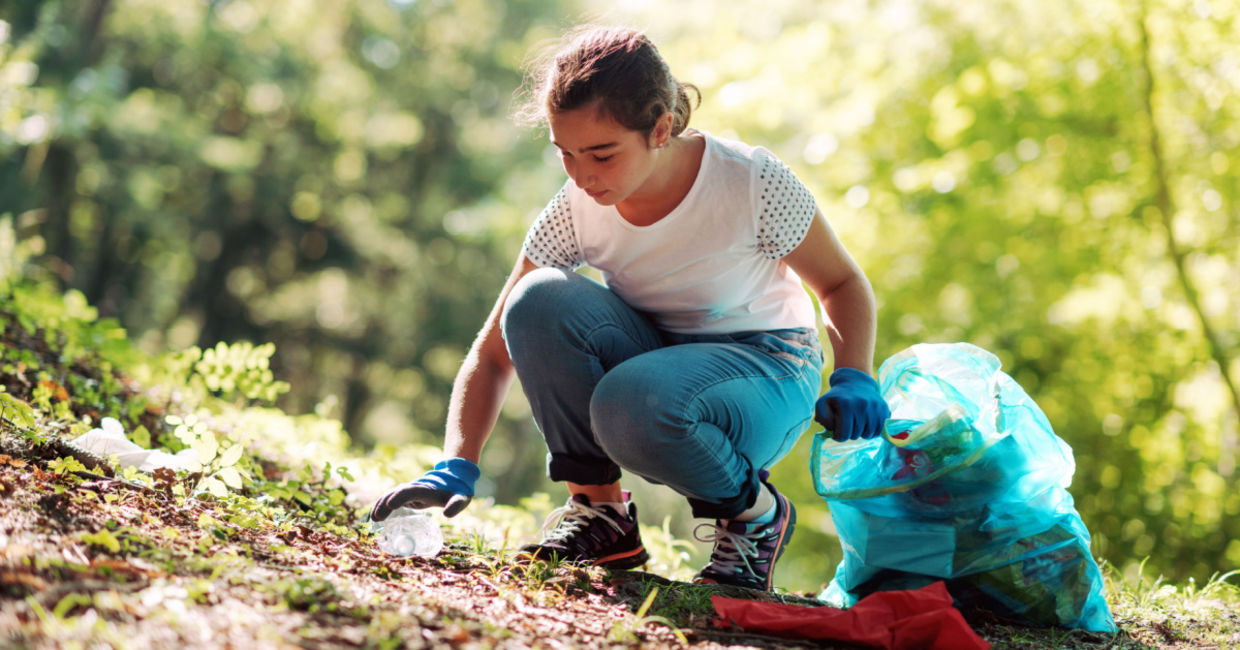 Teenage girl cleaning a community park. Teenage girl cleaning a community park.