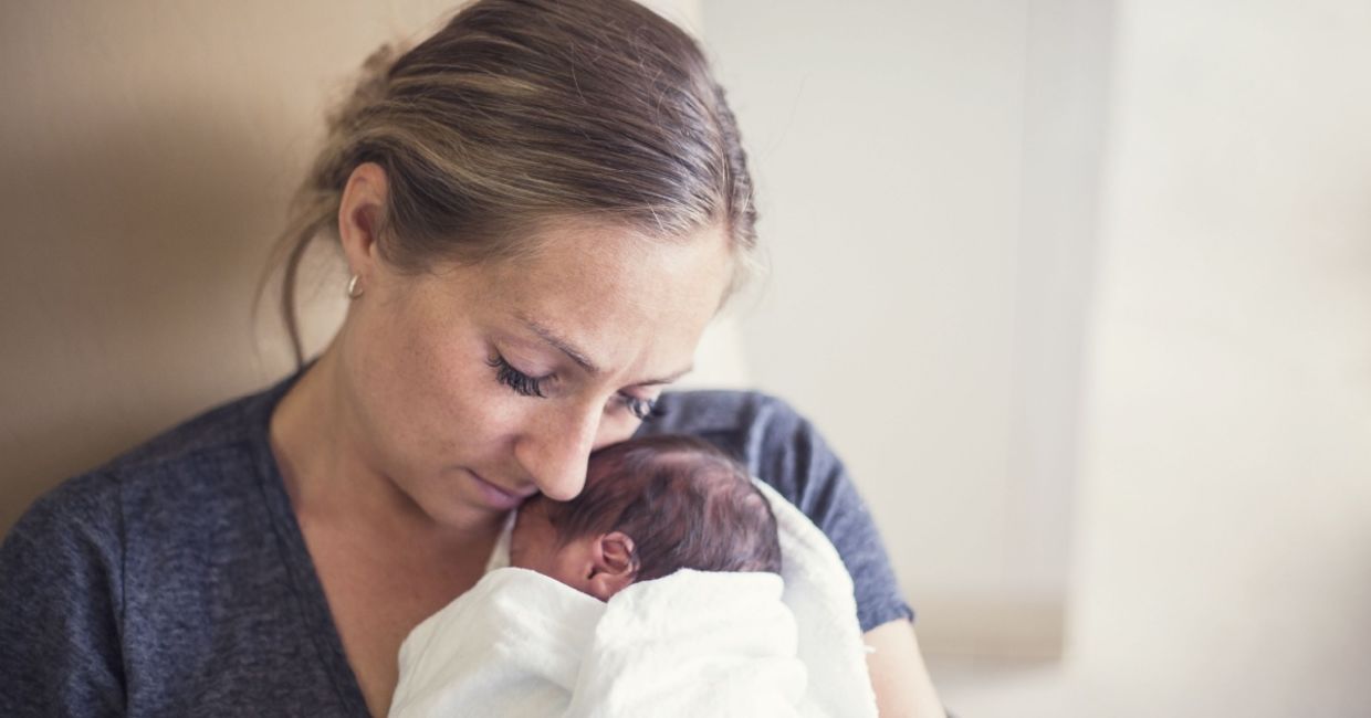 Cuddling a premature infant. Cuddling a premature infant.