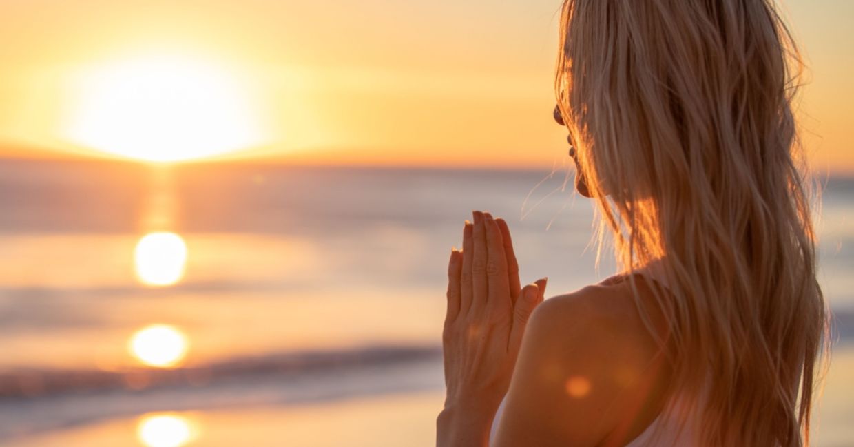 Girl meditating at sunset on beach Girl meditating at sunset on beach