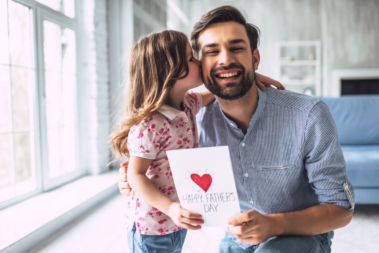 A daughter giving a card to her father, A daughter giving a card to her father,