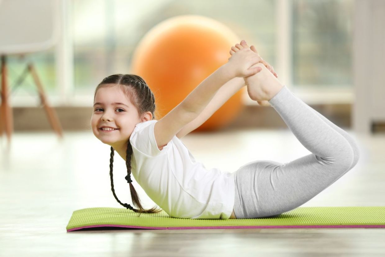 Girl doing yoga on a mat. Girl doing yoga on a mat.