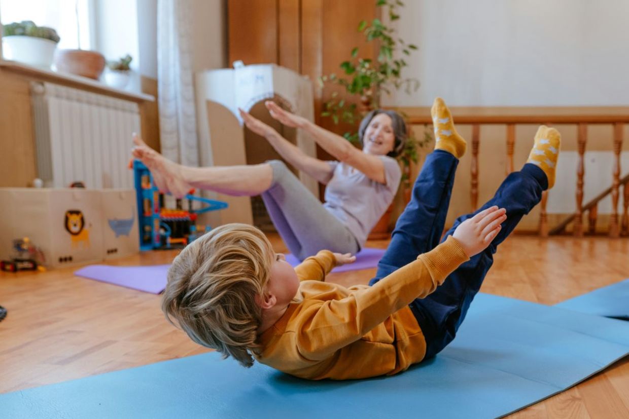Child practicing yoga with grandmother. Child practicing yoga with grandmother.