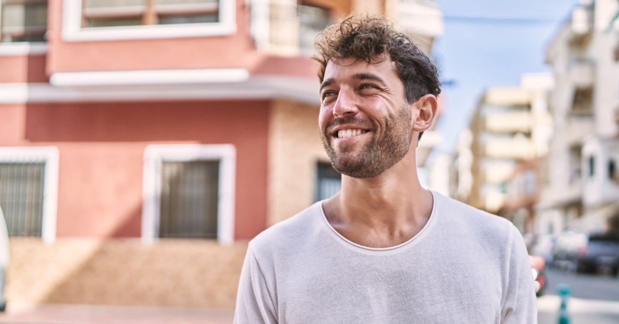 Young Spaniard walking along the street in the summertime. Young Spaniard walking along the street in the summertime.