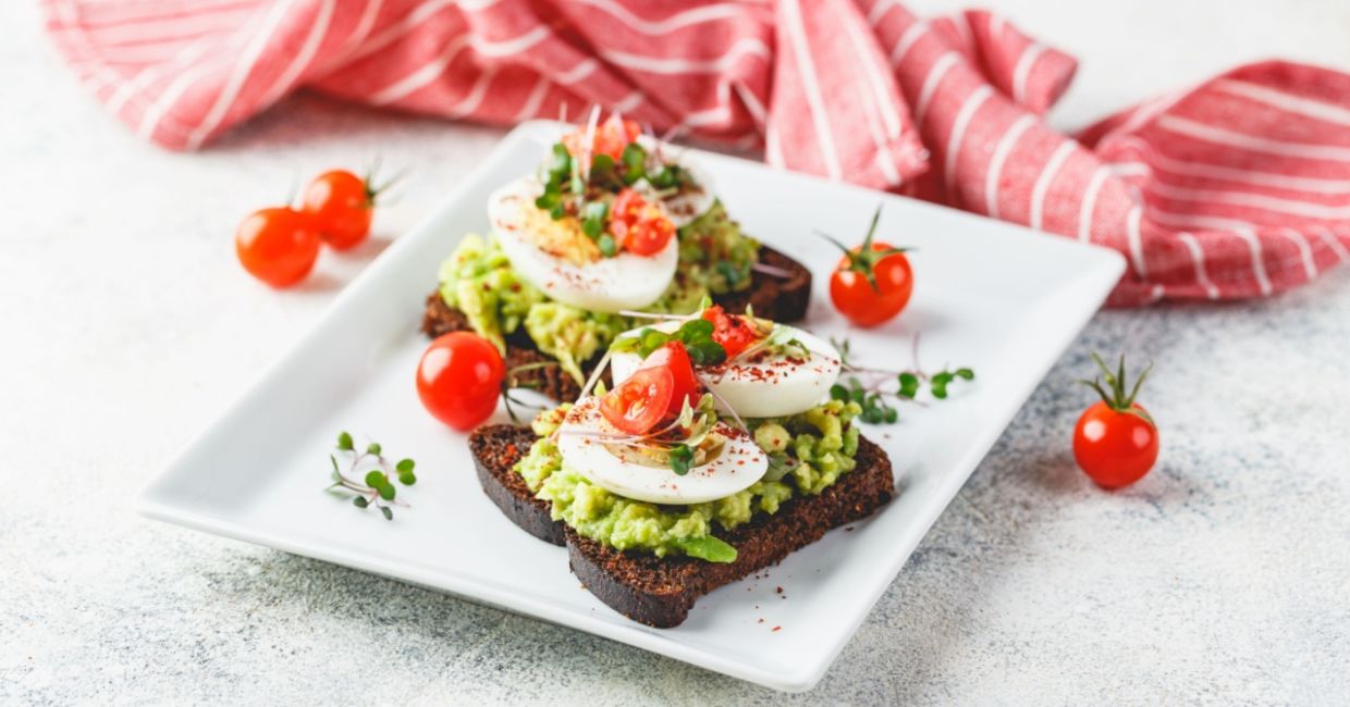 Mashed avocado and egg on rye toast. Mashed avocado and egg on rye toast.