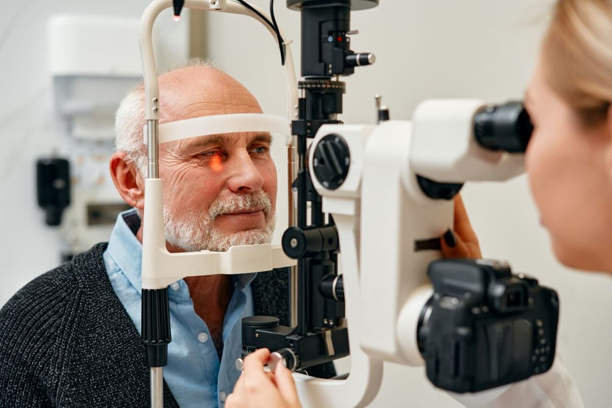 A senior getting an eye exam. A senior getting an eye exam.