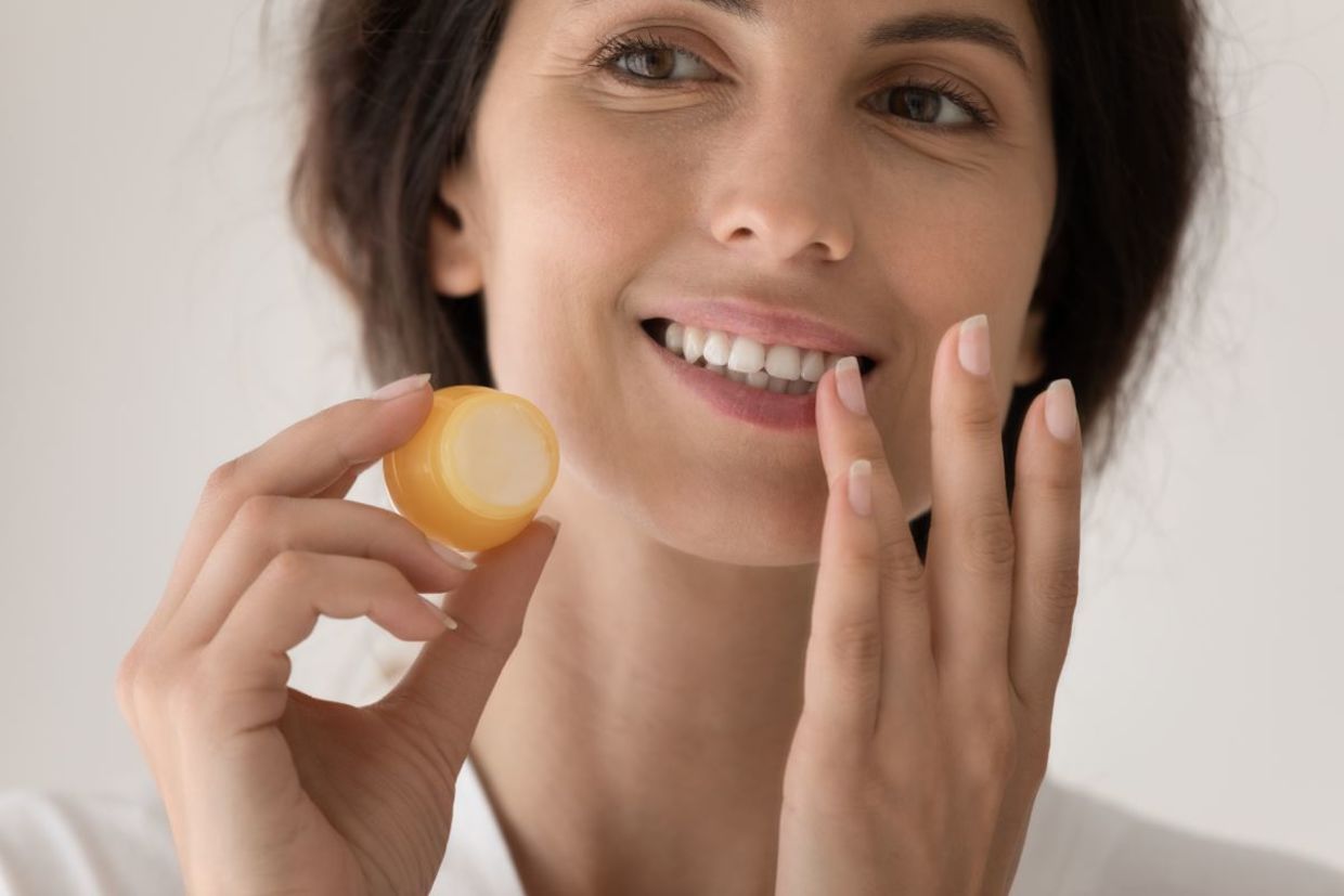 Appling DIY lip balm to chapped lips. Appling DIY lip balm to chapped lips.