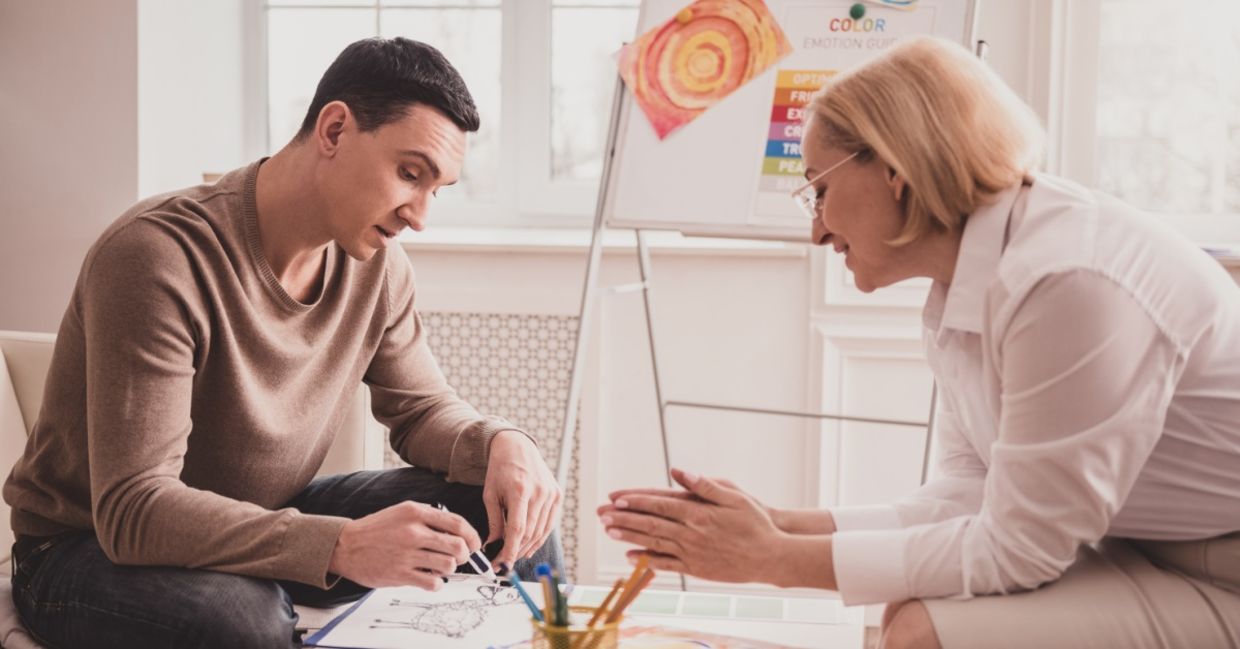 A young man in an art therapy session. A young man in an art therapy session.