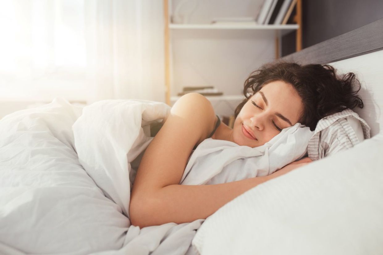 A woman sleeping on her side. A woman sleeping on her side.