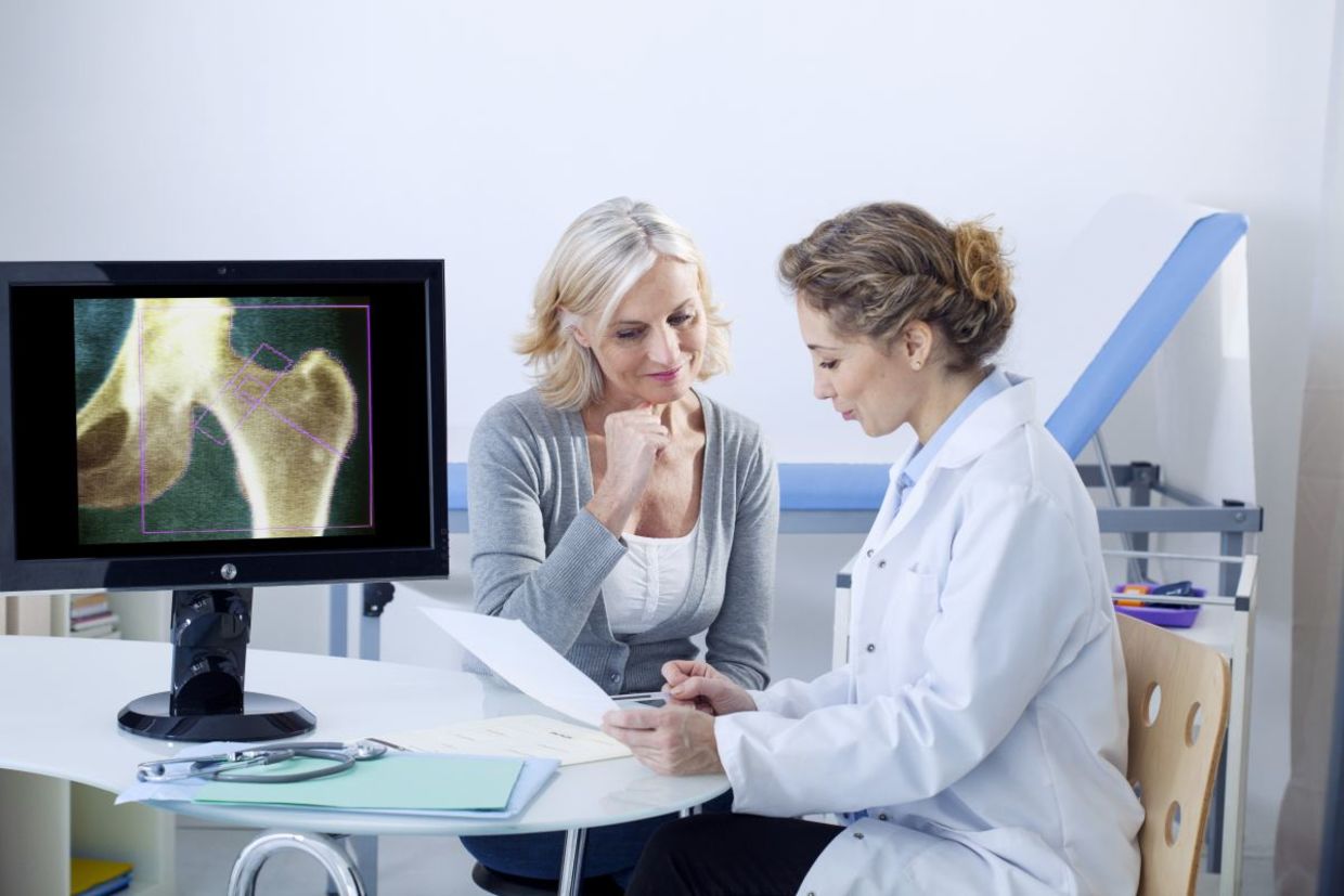 A doctor and patient looking at x-rays.
