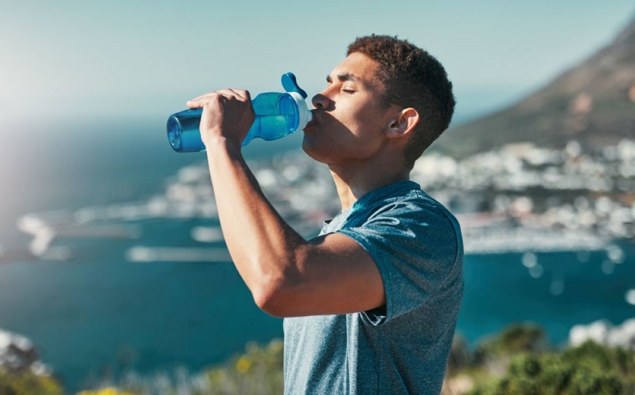 A man drinks water. A man drinks water.